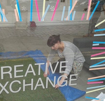 Lauren McLaughlin installing exhibition at Creative Exchange 